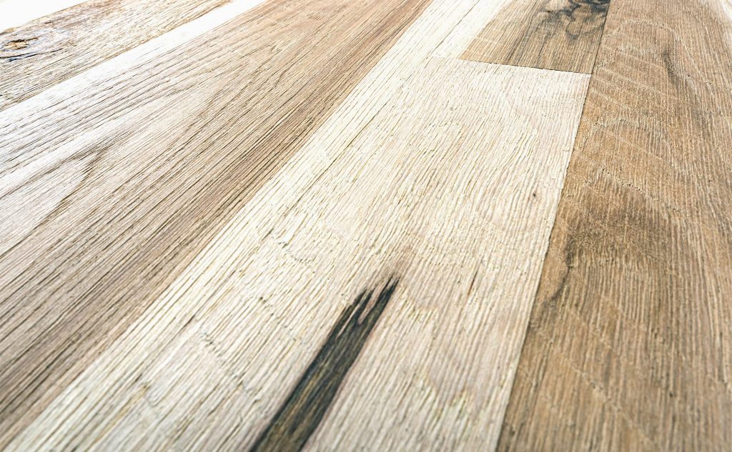 Hickory hardwood flooring with skip sawn wire brushed texture close up.