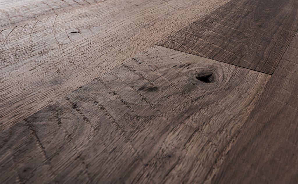 Walnut hardwood flooring with skip sawn and wire brush texture close up.