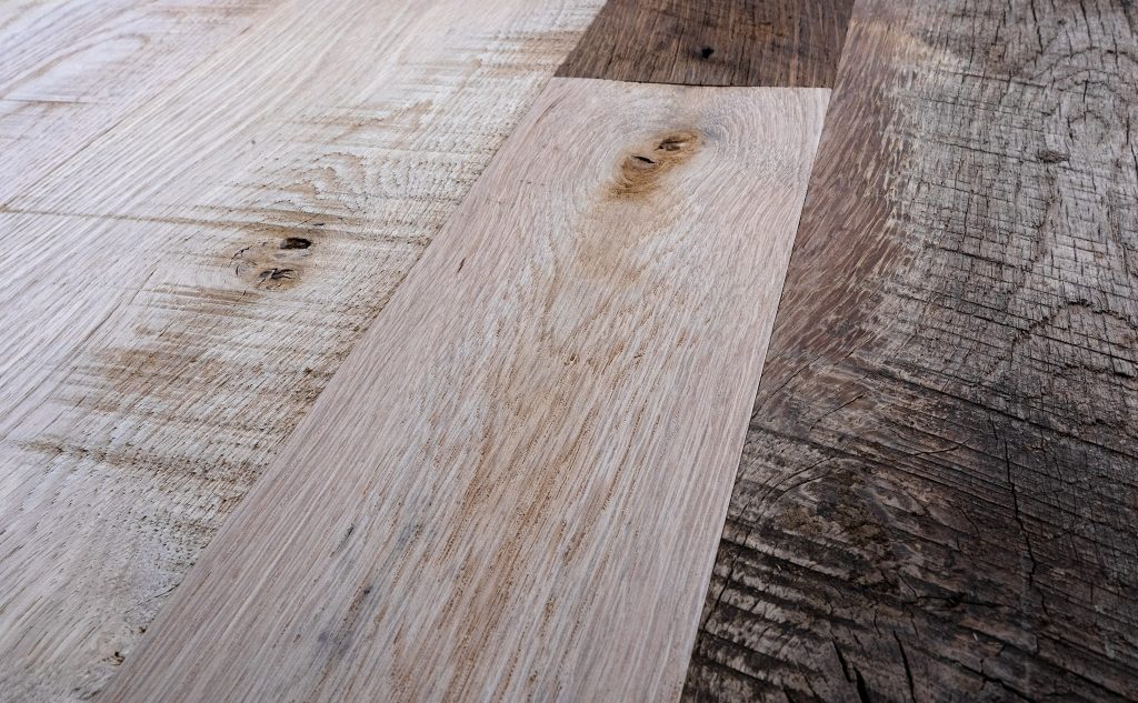 Antique oak hardwood and new distressed oak flooring close up.