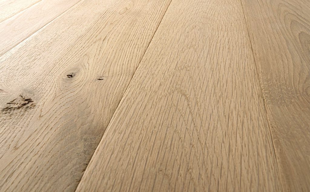 White oak hardwood flooring with foot worn texture close up.