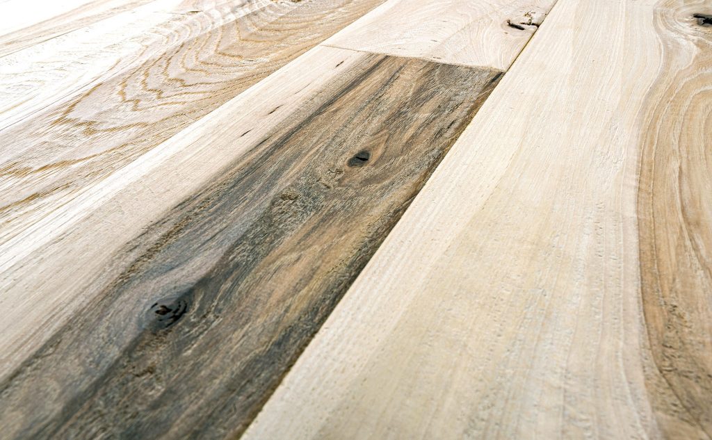 Hickory hardwood flooring with hand scraped texture close up.