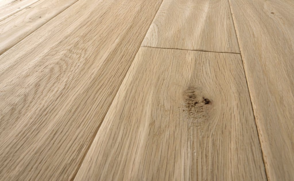 White oak hardwood flooring with hand scraped texture close up.