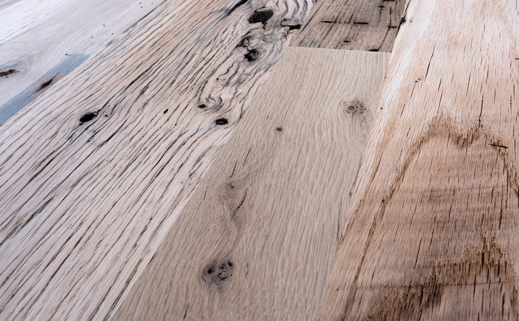 Antique oak hardwood flooring with remilled texture close up.