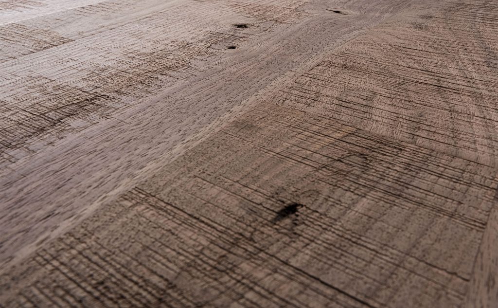 Walnut hardwood flooring with skip band texture close up.