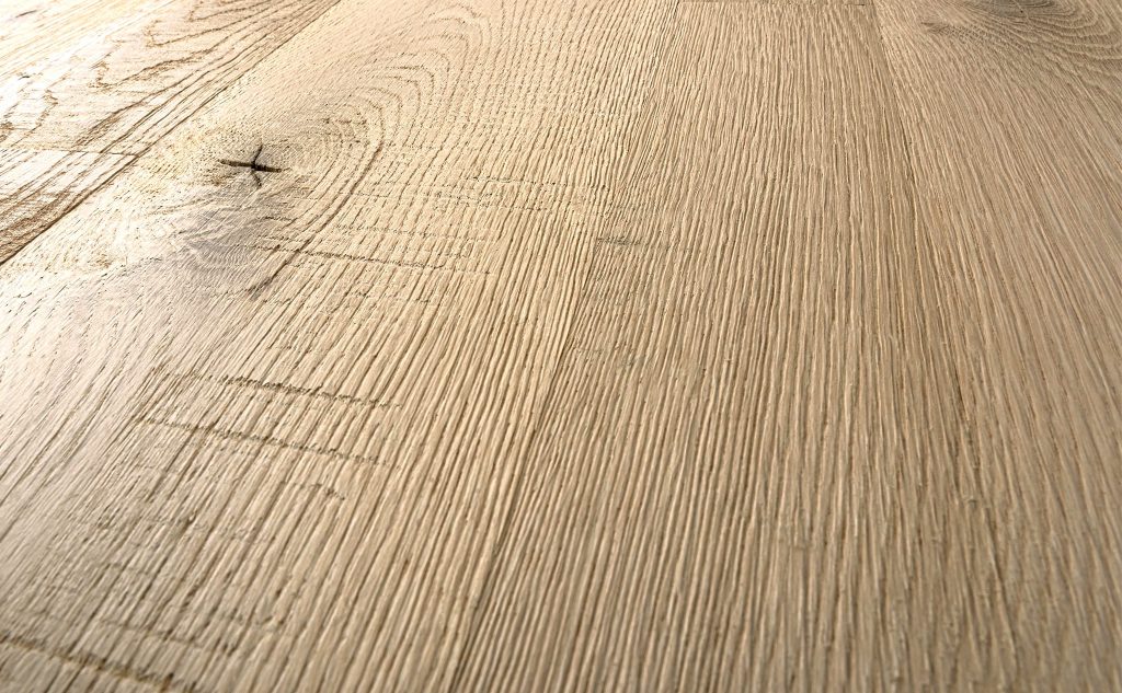 White oak hardwood flooring with wire brushed skip band texture close up.