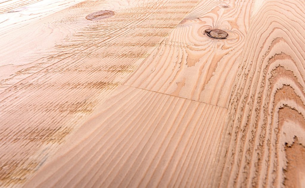Douglas fir hardwood flooring with skip planed texture close up.