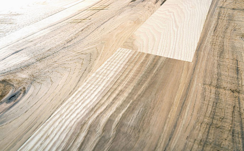 Hickory hardwood flooring with skip planed texture close up.