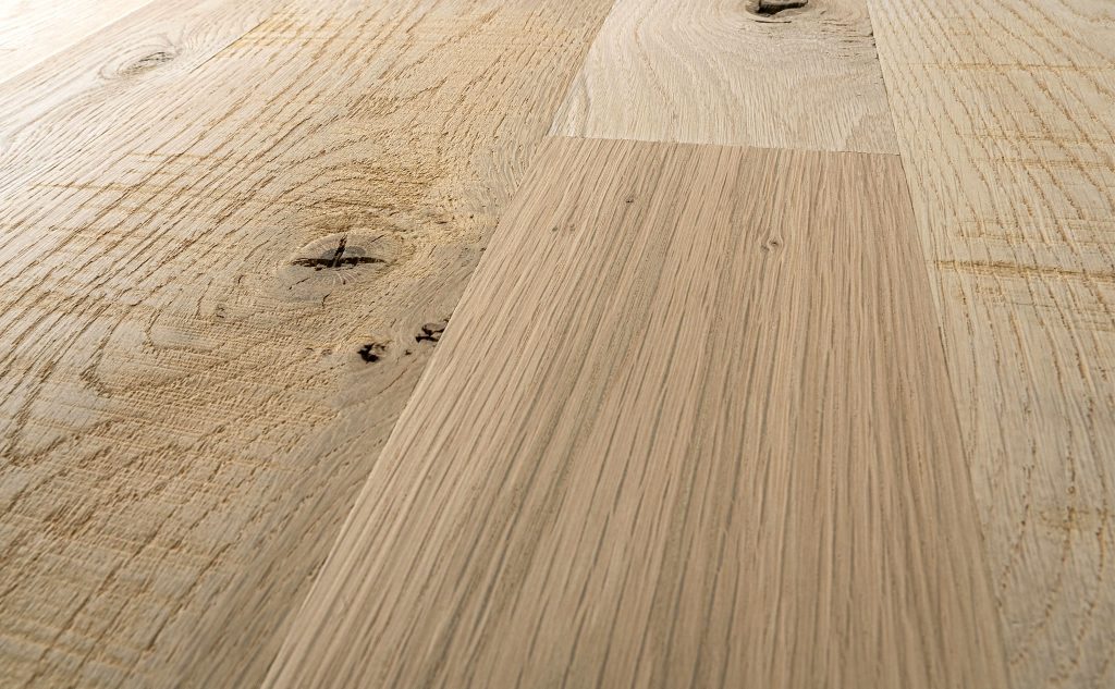 White oak hardwood flooring with skip planed texture close up.