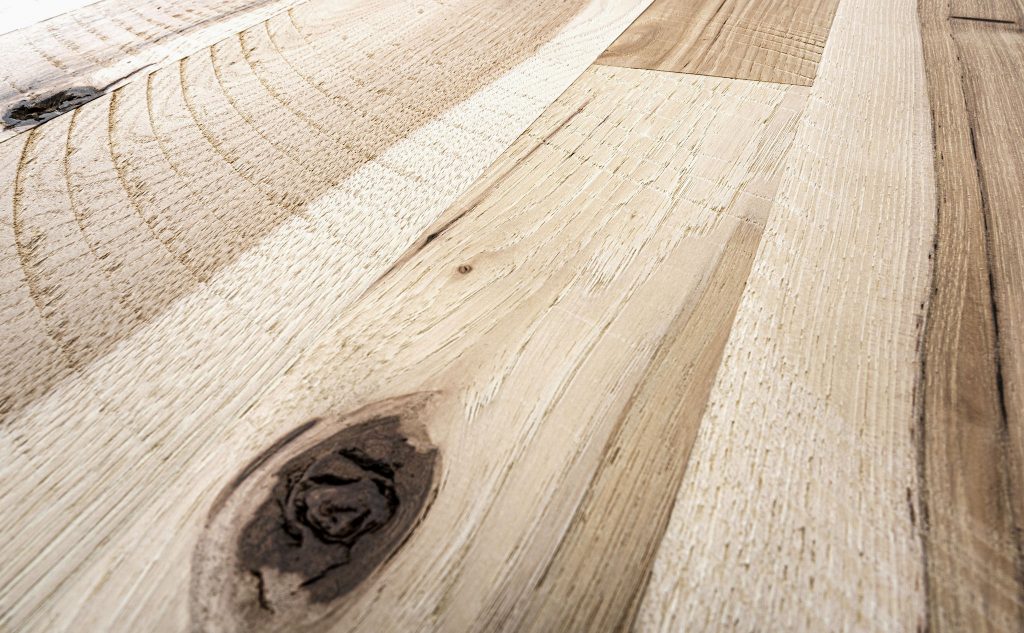Hickory hardwood flooring with skip sawn texture close up.