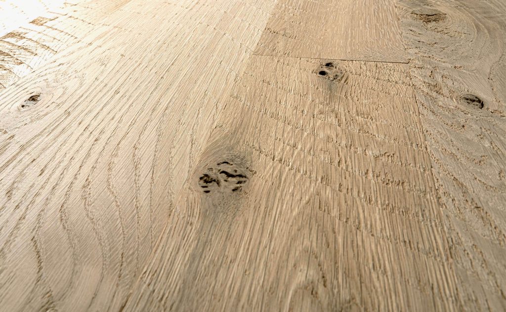 White oak hardwood flooring with skip sawn texture close up.
