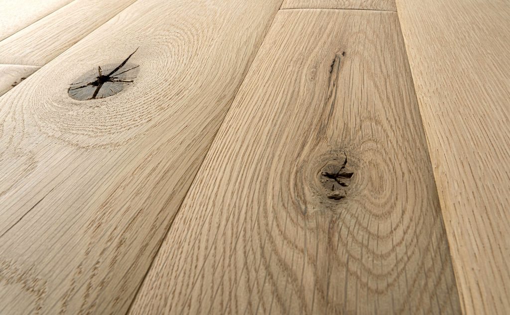 Smooth white oak hardwood flooring with chalet texture close up.