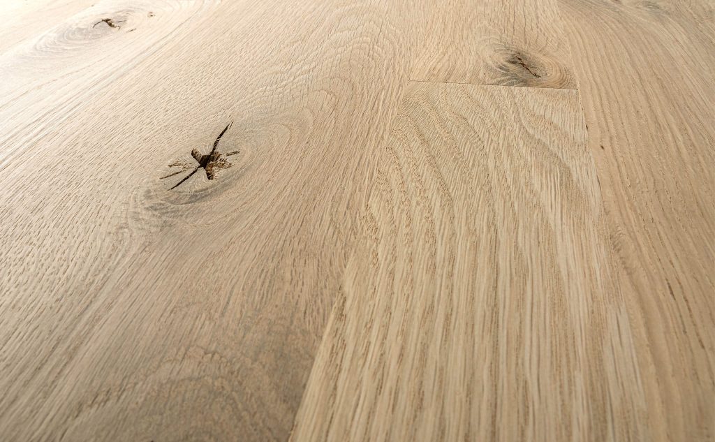 Smooth white oak hardwood flooring close up.