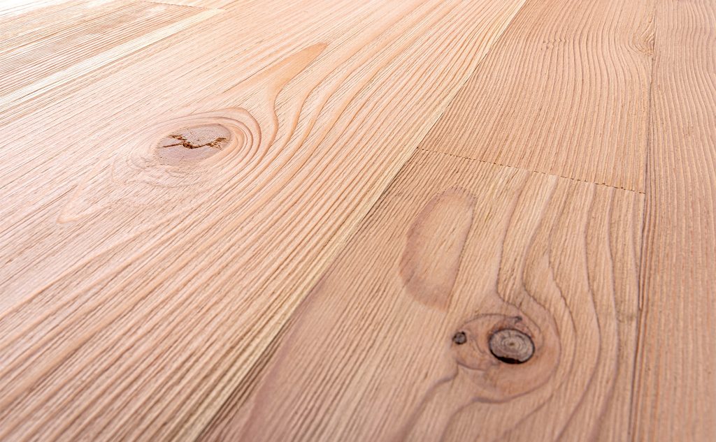 Douglas fir hardwood flooring with wire brushed texture close up.
