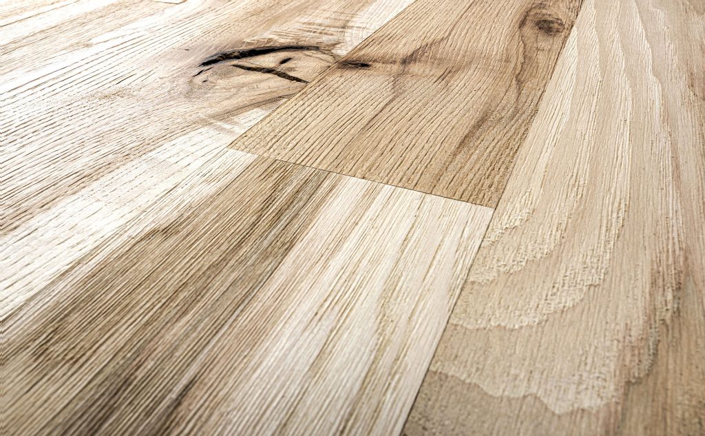 Hickory hardwood flooring with wire brushed texture close up.